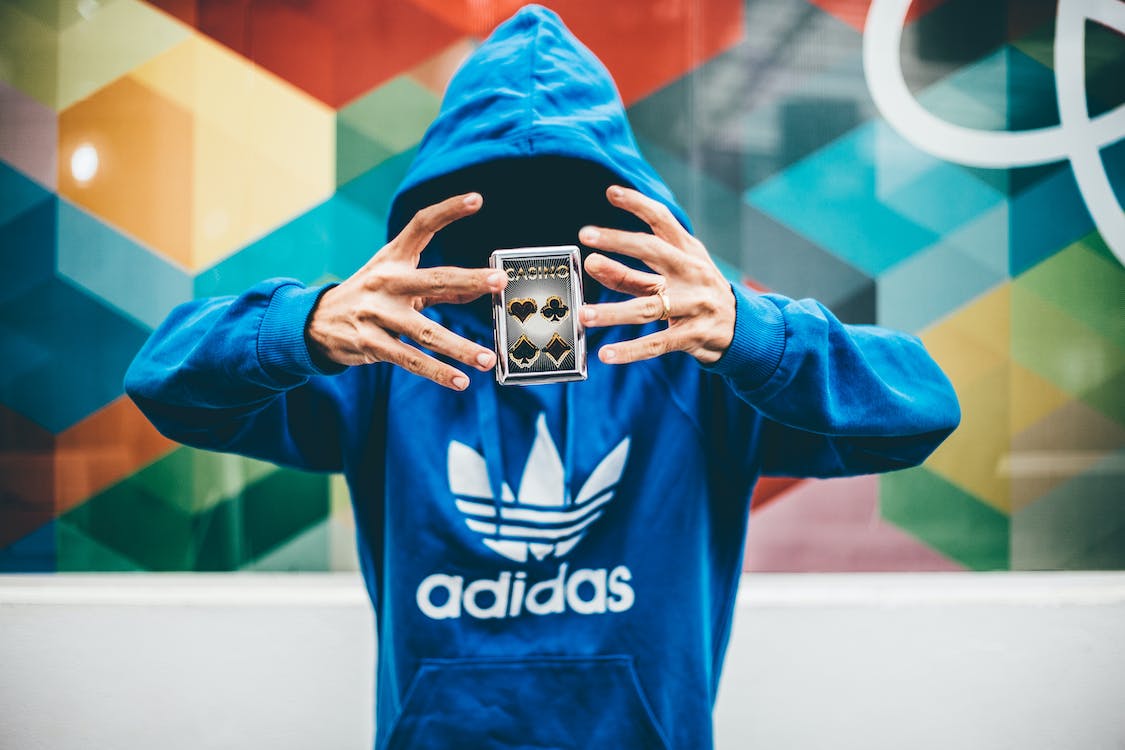 Free Man in Blue Adidas Hoodie Doing Magic Trick Stock Photo