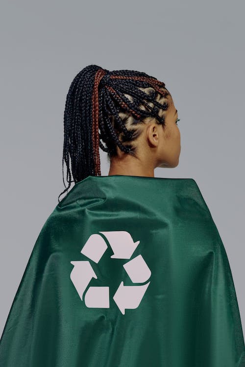 Free A Back View of a Woman in Green Cape promoting textile recycling