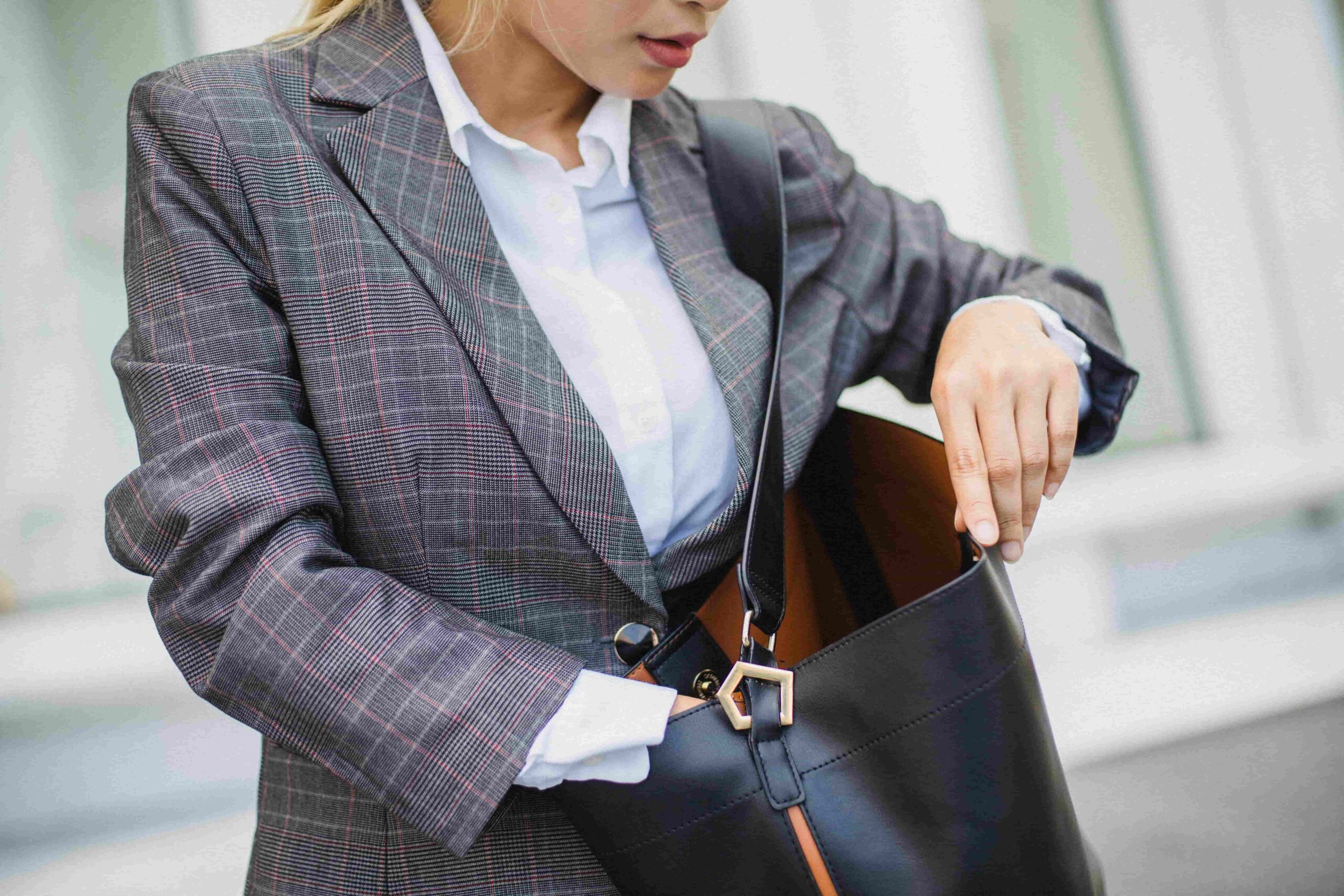 Professional woman in business casual outfit with tailored blazer and elegant accessories